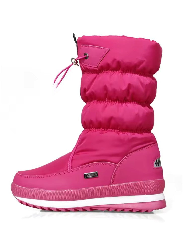 Bottes de neige en position debout sur un sol en bois