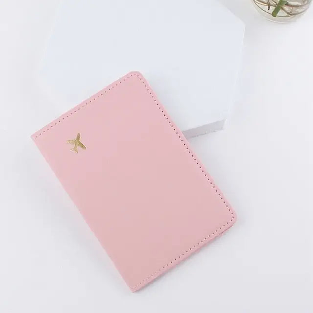 Pochette rose avec motif avion doré, vue de face