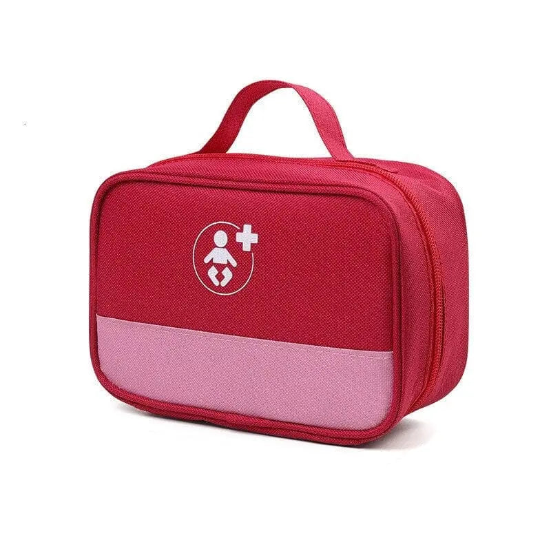 Trousse de voyage bébé rouge posée sur une surface blanche