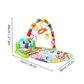 Bébé jouant sur un tapis musical, explorant les textures