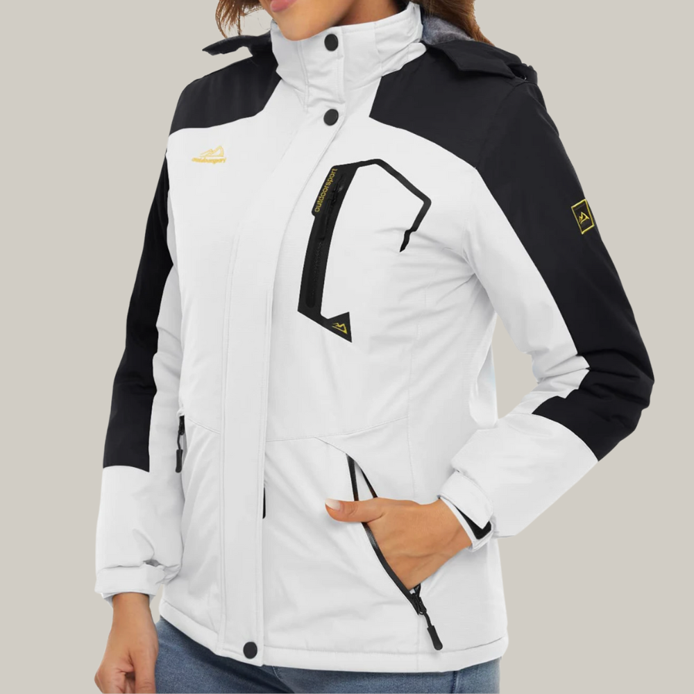 Veste de ski femme avec capuche réglable en montagne enneigée