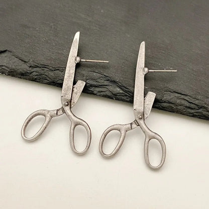 Vue d'ensemble des boucles d'oreilles ciseaux avec ombre