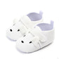 Vue de profil des chaussons bébé avec semelles antidérapantes