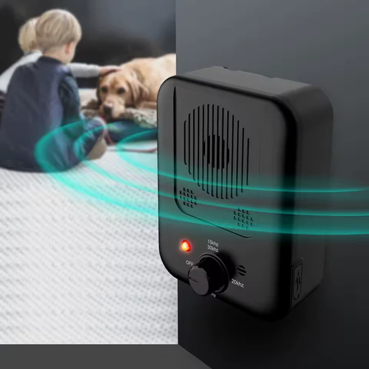 Dispositif ultrasonique anti-aboiement posé sur une table en bois
