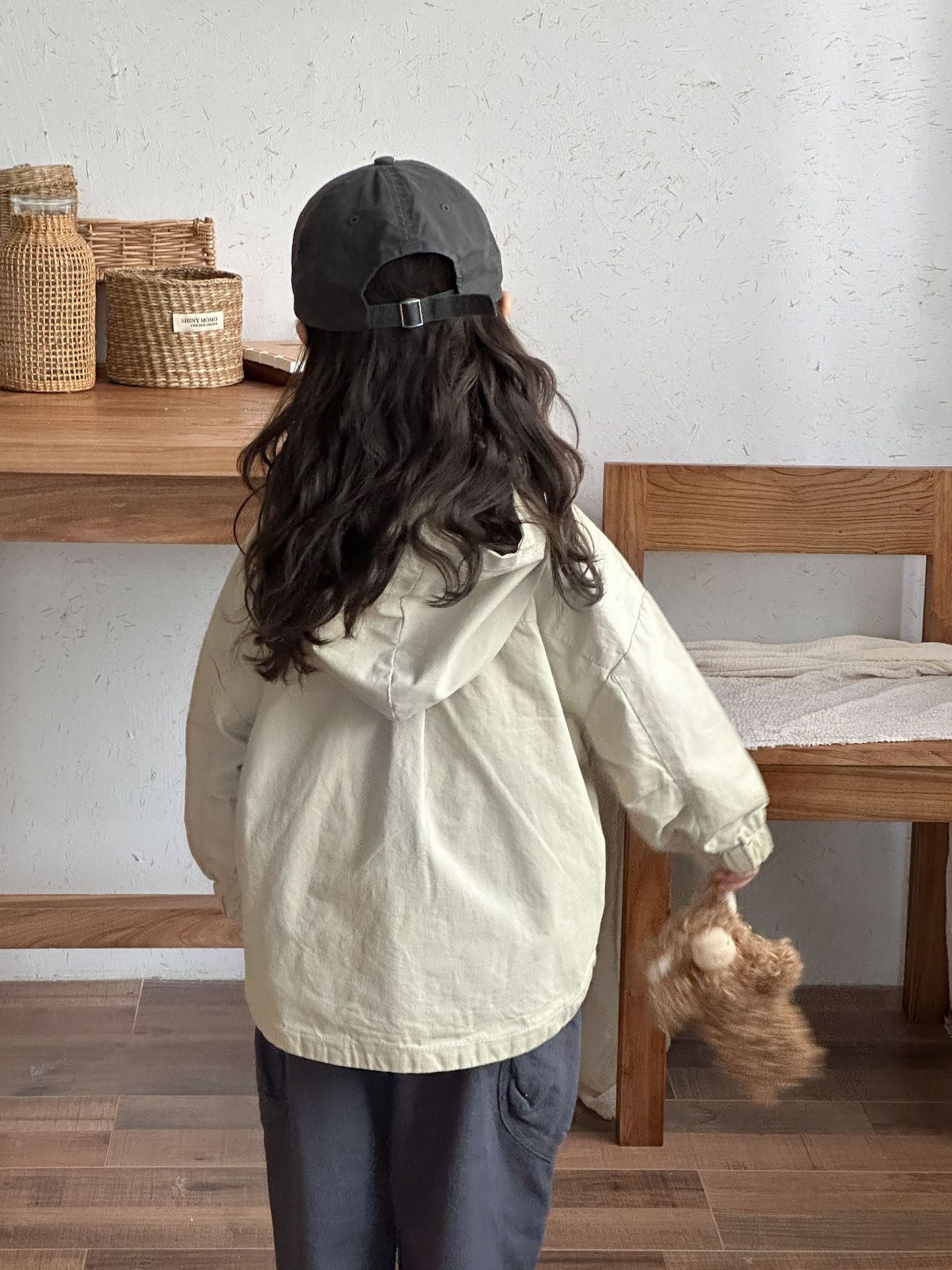 Enfant portant la parka beige avec capuche et poches