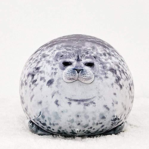 Phoque en peluche rond sur une couverture moelleuse