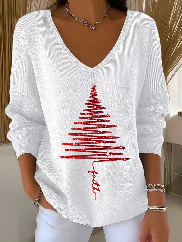 Pull de Noël en tricot doux posé sur une surface