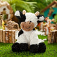 Peluche vache douce avec pelage tacheté et petites cornes
