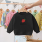 Pull fraise, gros plan sur les coutures