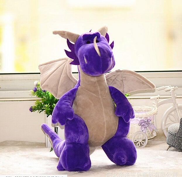 Dragon en peluche tenant une petite étoile dorée