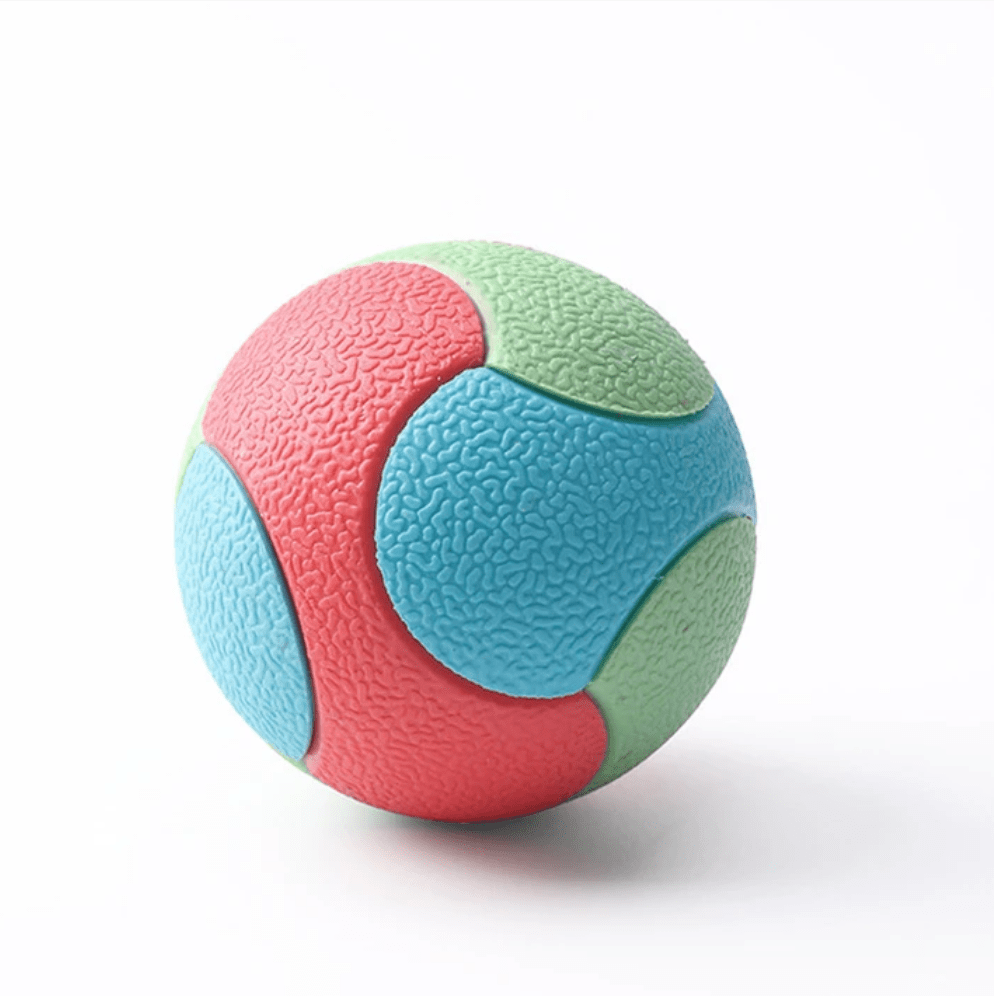 Balle multicolore posée sur une surface en bois