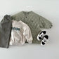 Veste noire matelassée pour enfant, détails des boutons