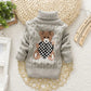 Vue de dos d'un pull enfant en fibres acryliques épaisses