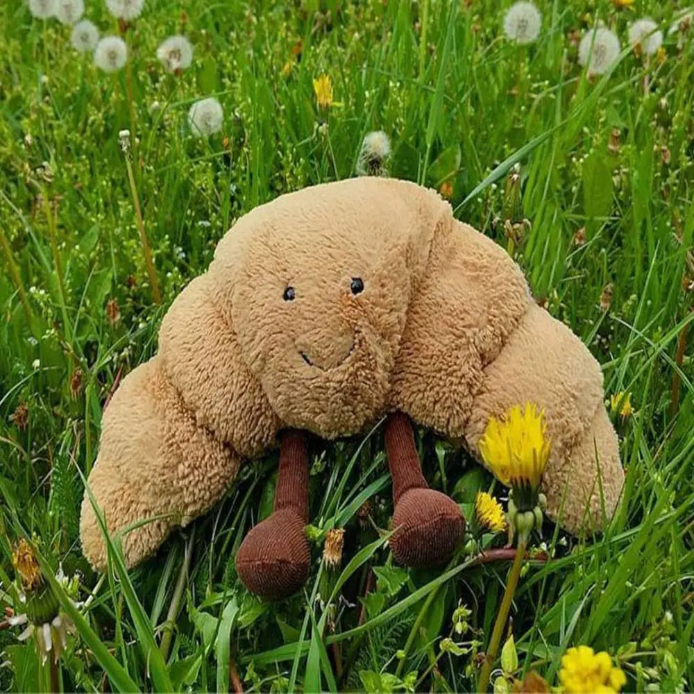 Peluche croissant souriant vue de face sur fond blanc