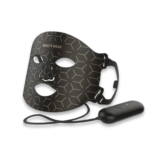 Masque facial LED rouge posé sur une surface, prêt à l'utilisation
