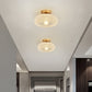 Lampe de plafond avec ampoule E27 visible à travers le verre
