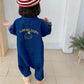 Combinaison enfant bleu et beige avec motifs ludiques
