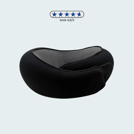 Coussin de voyage noir posé sur une surface en bois clair