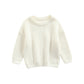 Gros plan sur la maille d'un pull enfant, couleur unie