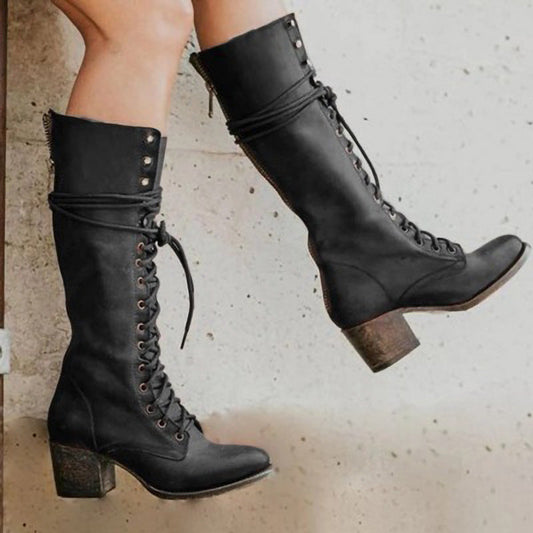 Vue d'ensemble des bottes montantes noires sur fond neutre