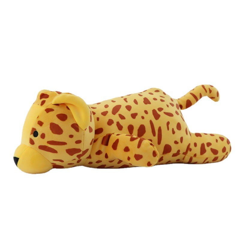 Dinosaure en peluche posé sur un canapé