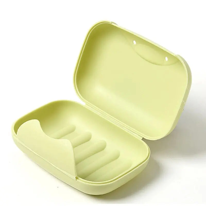 Boîte à savon ouverte montrant l'intérieur vide, plastique coloré
