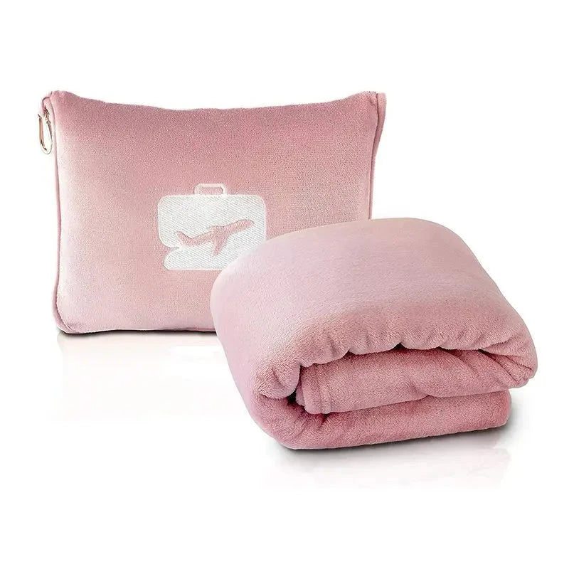 Couverture de voyage rose dépliée sur un siège d'avion