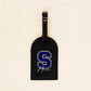 Étiquette valise noire avec initiale S en relief