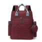 Sac à dos à langer rouge avec multiples compartiments