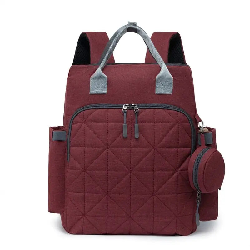 Sac à dos à langer rouge avec multiples compartiments