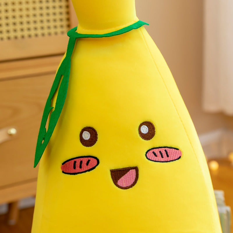 Peluche banane avec visage souriant et coque pelée