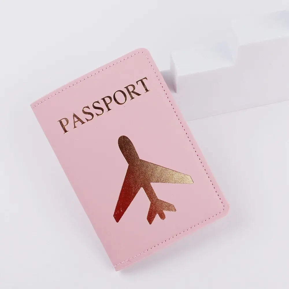 Protège-passeport rose, avion doré sur la couverture