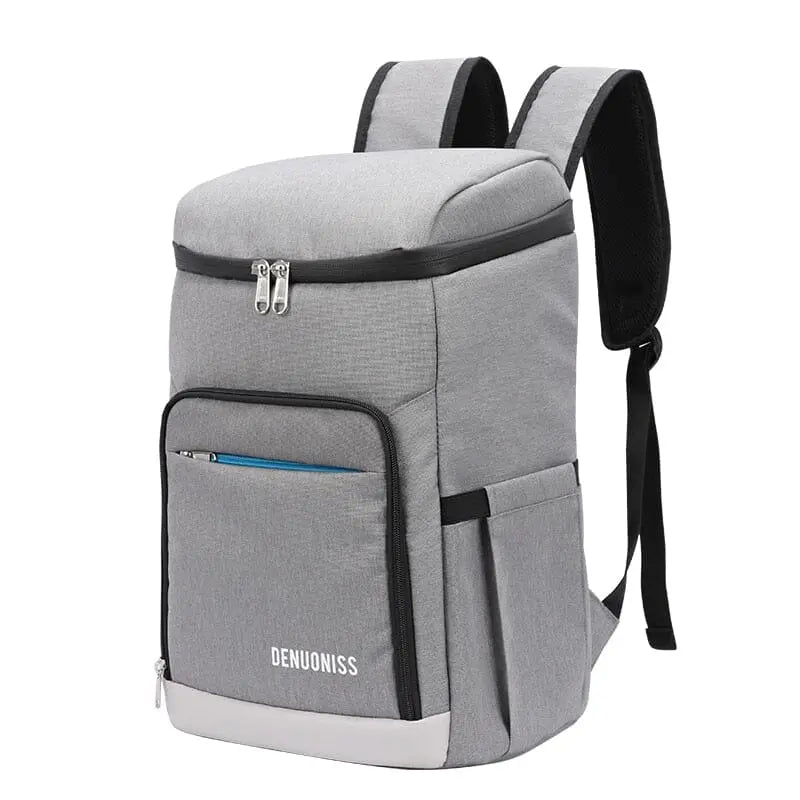 Sac à dos isotherme gris posé sur une surface plane
