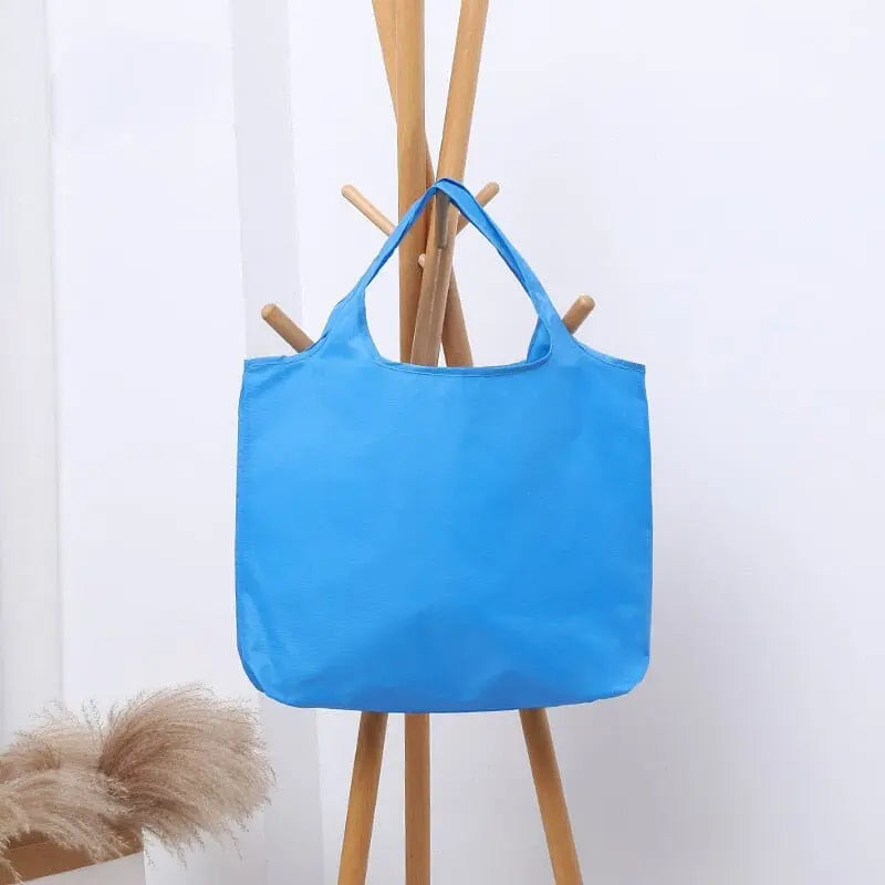 Sac bleu pliable, en tissu Oxford, avec poignées visibles