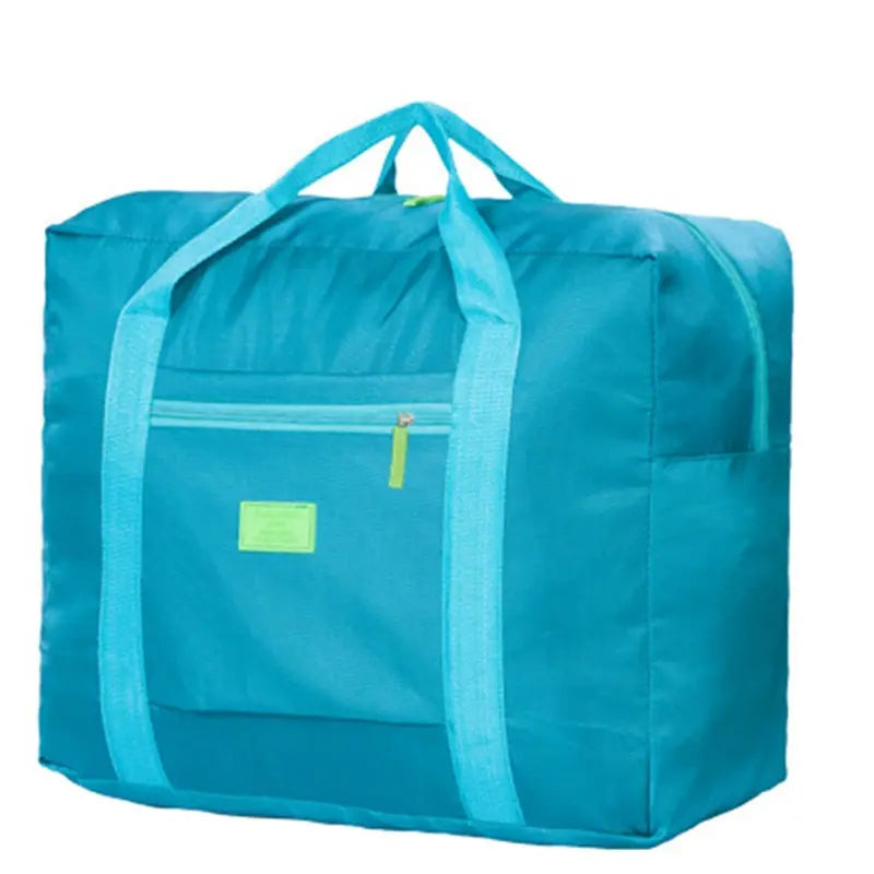 Sac de voyage pliable turquoise, posé sur une table